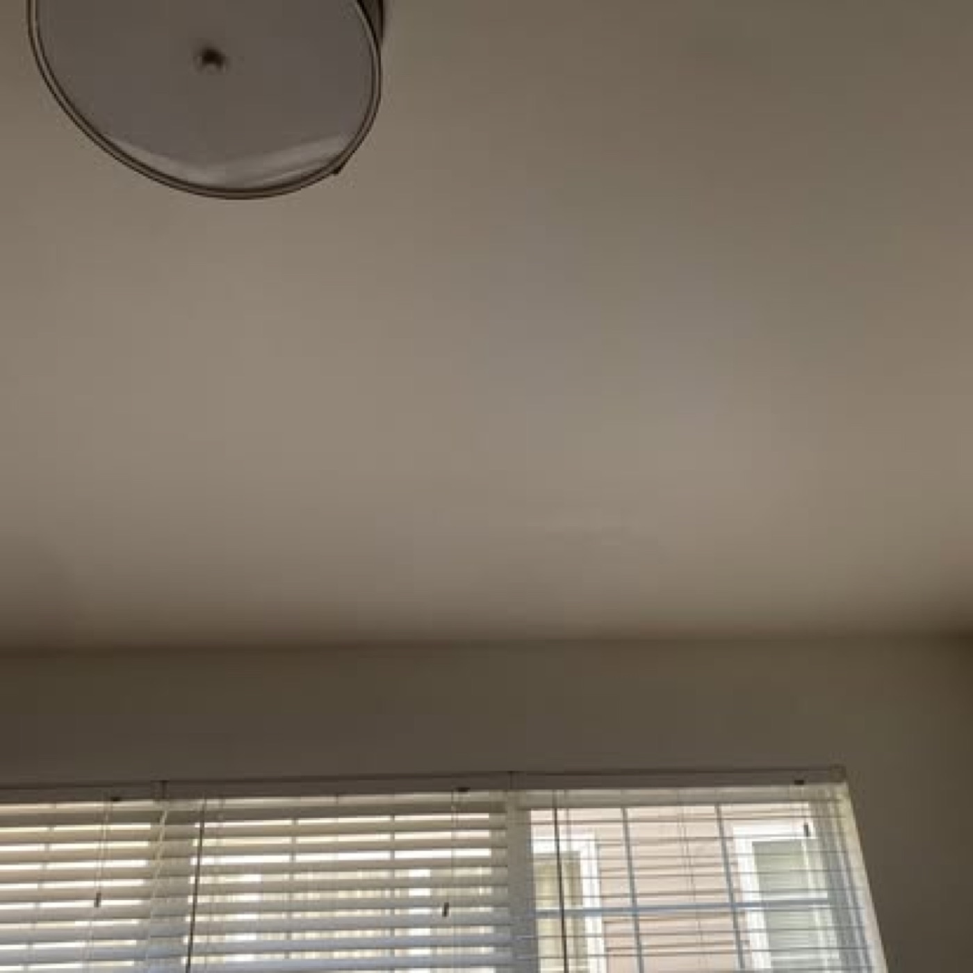Repaired ceiling painted smooth, damage invisible