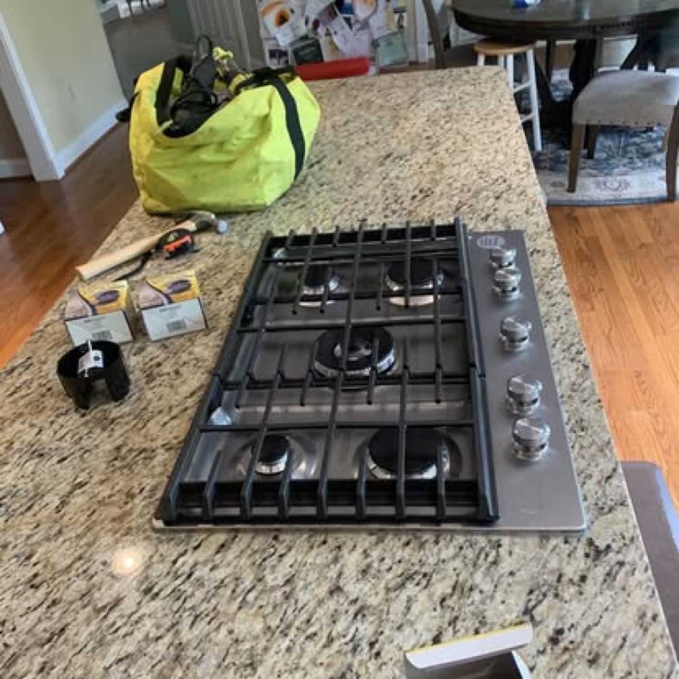 New 5-burner gas cooktop installed in granite countertop