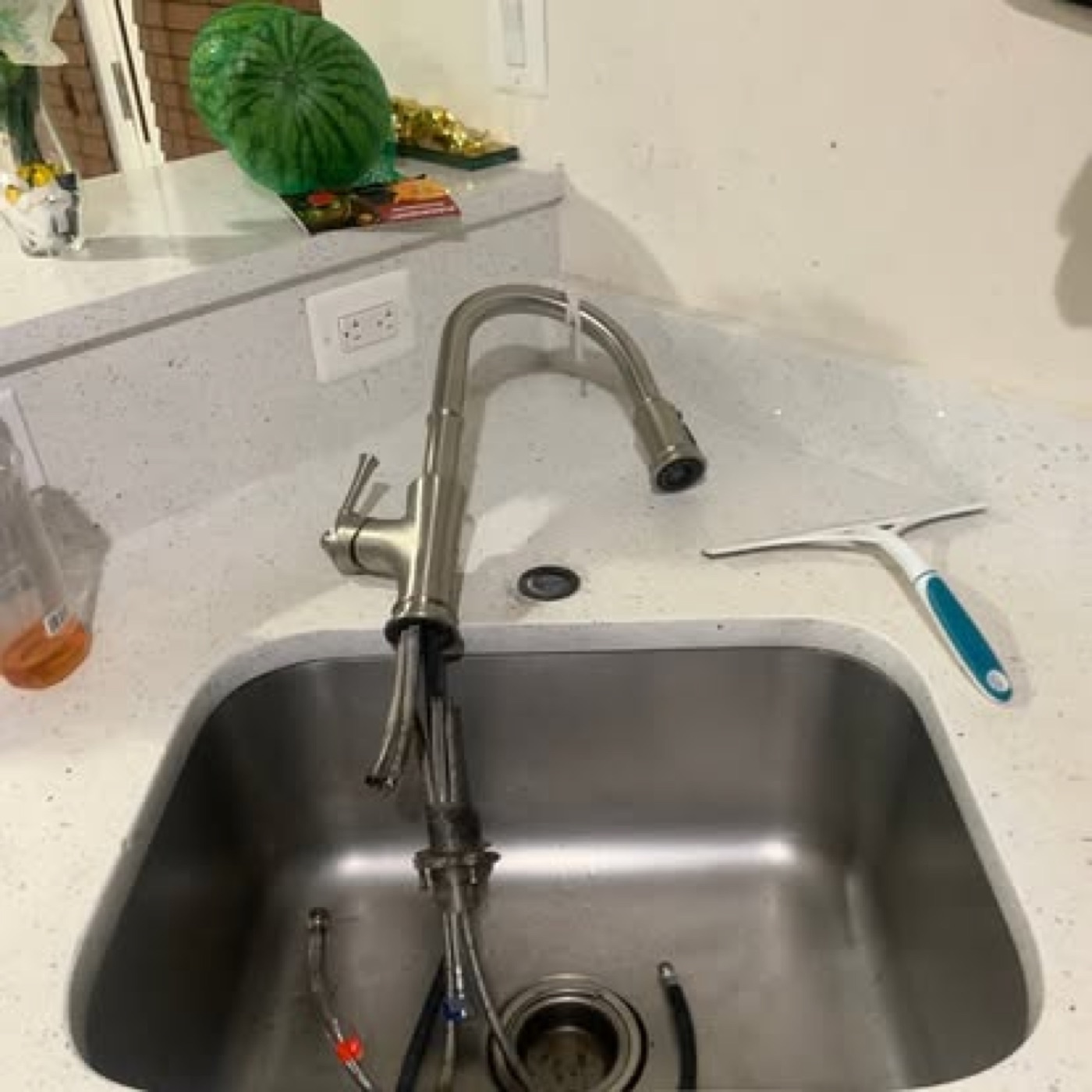 New faucet mid-installation with supply lines being connected